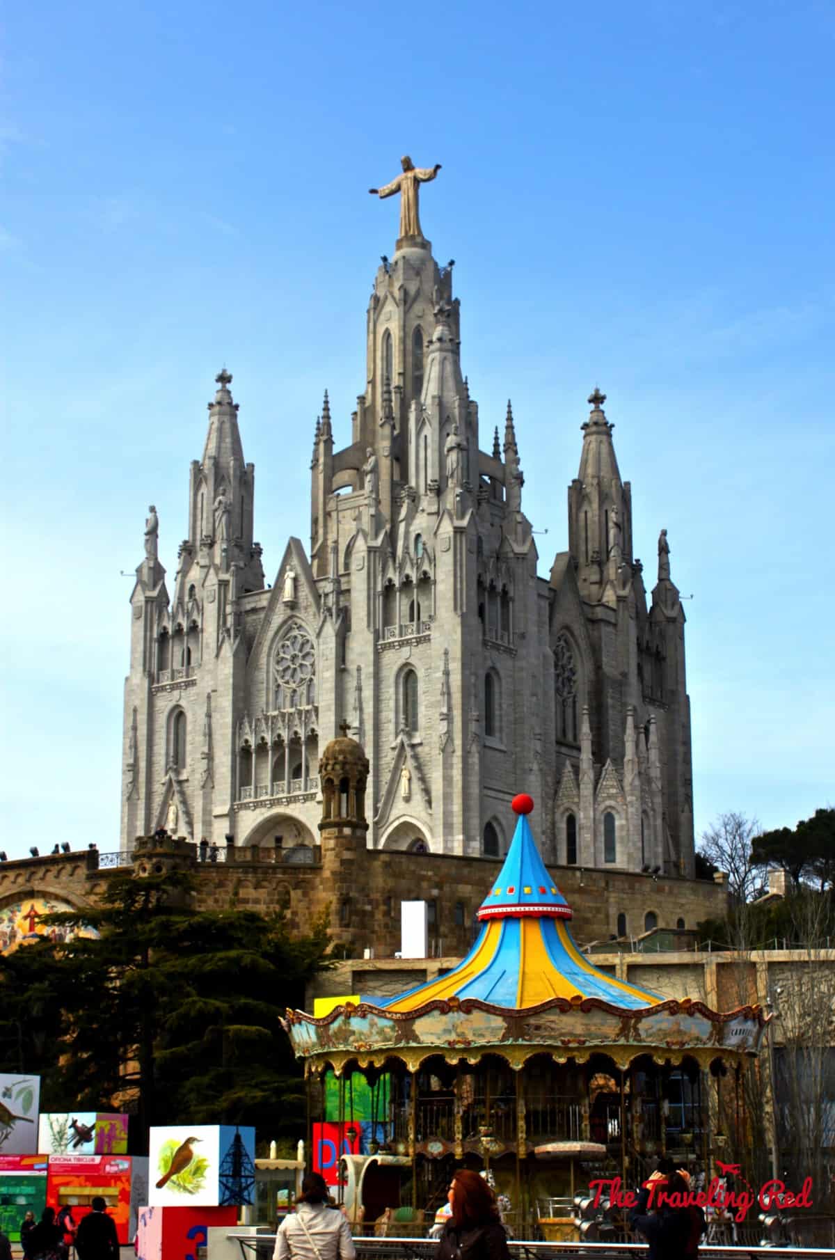 The Sagrat Cor overlooking the Tibidabo Amusement Park  in Tibidabo. Tibidabo is a mountain with an amusement park and church on the summit. It is the highest point in the city with incredible sweeping views of Barcelona Spain.