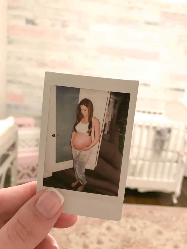 Last pregnant photo - a Polaroid of my bump right before heading to the hospital held inside our pink and white rustic chic nursery