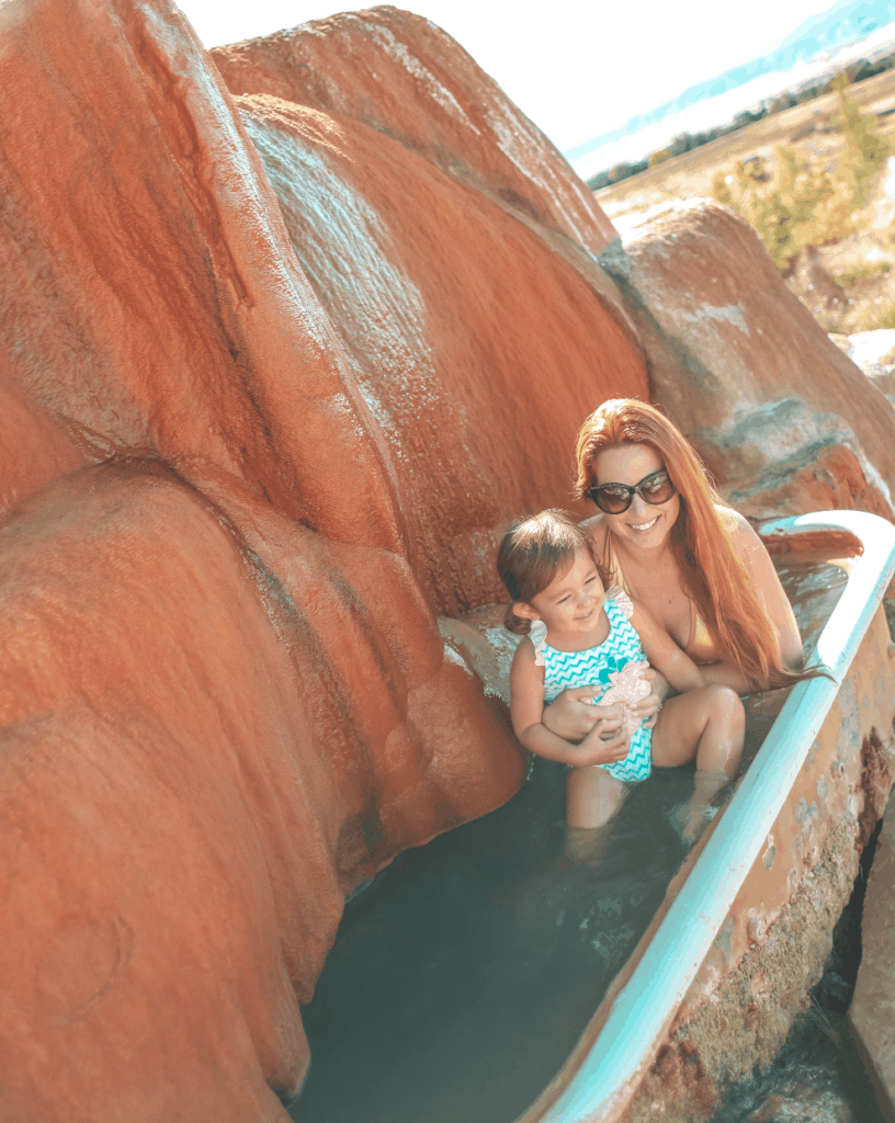 Visiting Mystic Hot Springs with my daughter in our school bus conversion, 2 Cool 4 Skool Bus. We did a 3 month road trip in our skoolie and Utah was one of our favorite places. Check out all the places you can't miss. Add them to your travel itinerary now.