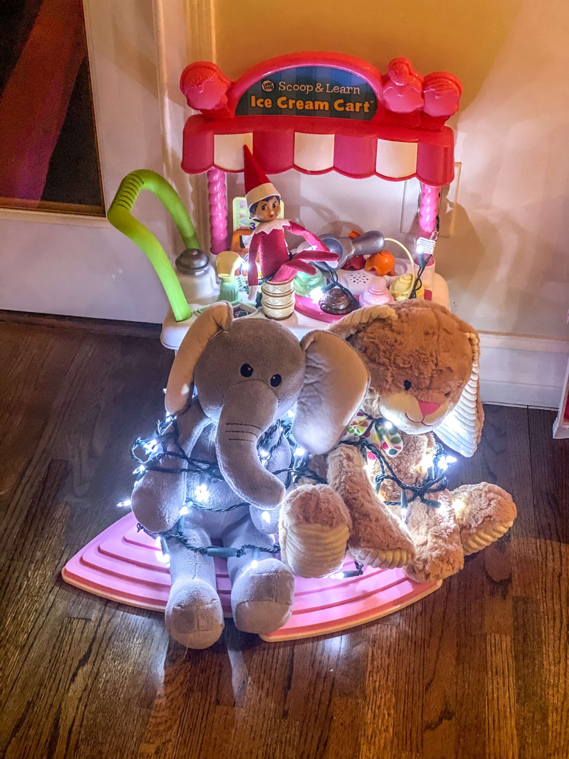 Used a strand of Christmas lights to tie up some stuffed animals. Fun & easy Elf on the Shelf ideas for your toddler or little kid. Quick to setup and lots of naughty and nice ideas, perfect to bring some Christmas magic to your home. #ElfOnTheShelf #ElfIdeas #ElfOnTheShelfIdeas #Christmas #ChristmasMagic