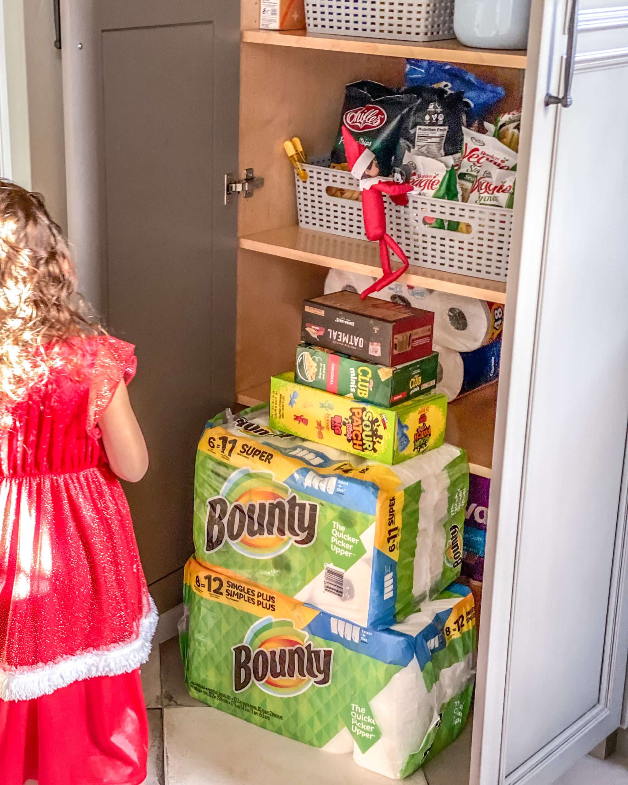 Our elf built a wall using household items from the pantry to get into the snacks. Fun & easy Elf on the Shelf ideas for your toddler or little kid. Quick to setup and lots of naughty and nice ideas, perfect to bring some Christmas magic to your home. #ElfOnTheShelf #ElfIdeas #ElfOnTheShelfIdeas #Christmas #ChristmasMagic