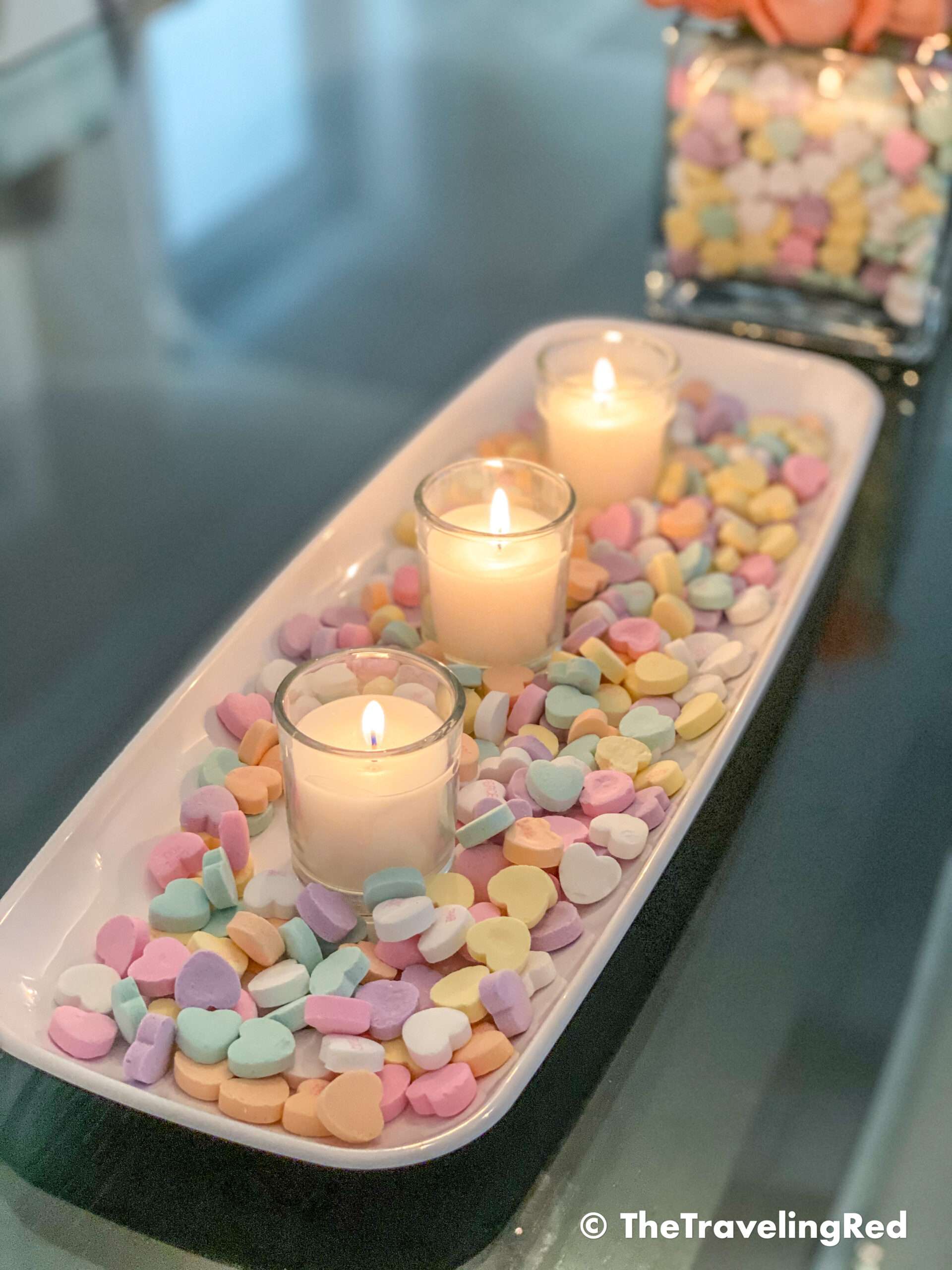 Valentine's Day Home Decor Dining Room Table Decor for a Valentines Day party using plastic trays, glass vases, sweetheart candies, votive candles & fresh roses - #valentinesday #valentinesdaydecor #homedecor #tabledecor #valentinesdayhomedecor
