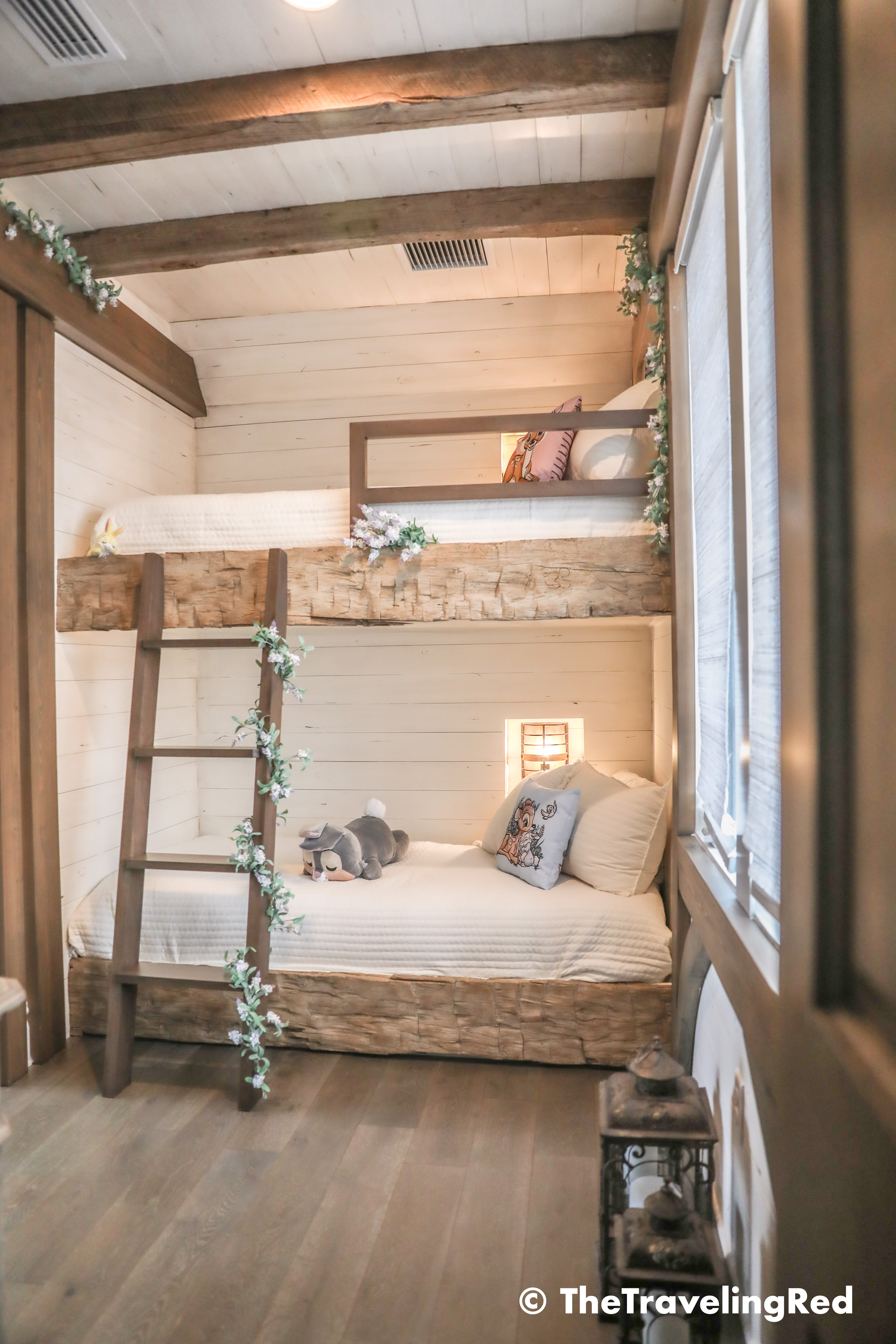 Bambi bunk bed room inside our Disney Golden Oak home. Inspiration for a tiny kids bedroom full of rustic charm and character. Reclaimed wood beams, shiplap, flowers and lanterns fill the room, along with Bambi details.