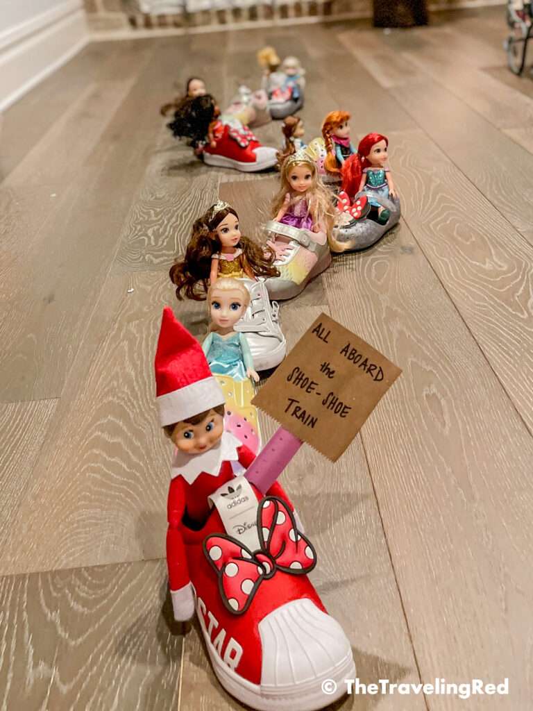 Naughty Elf on the shelf made a Shoe Shoe Train, much like a choo choo train, using her shoes and princess toys. Fun and easy elf on the shelf ideas for a naughty elf that are quick and easy using things you have at home.