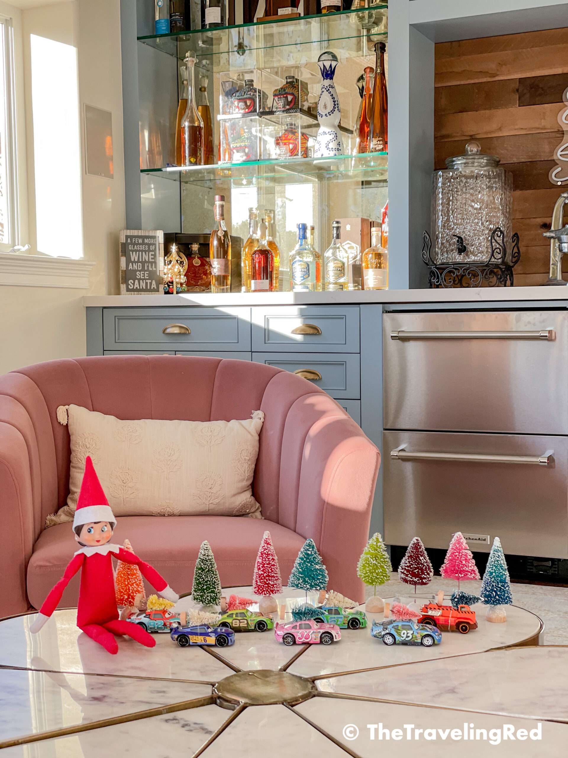 Naughty Elf on the shelf put tiny bottle bruch Christmas trees on all of the toy cars. Fun and easy elf on the shelf ideas for a naughty elf that are quick and easy using things you have at home.