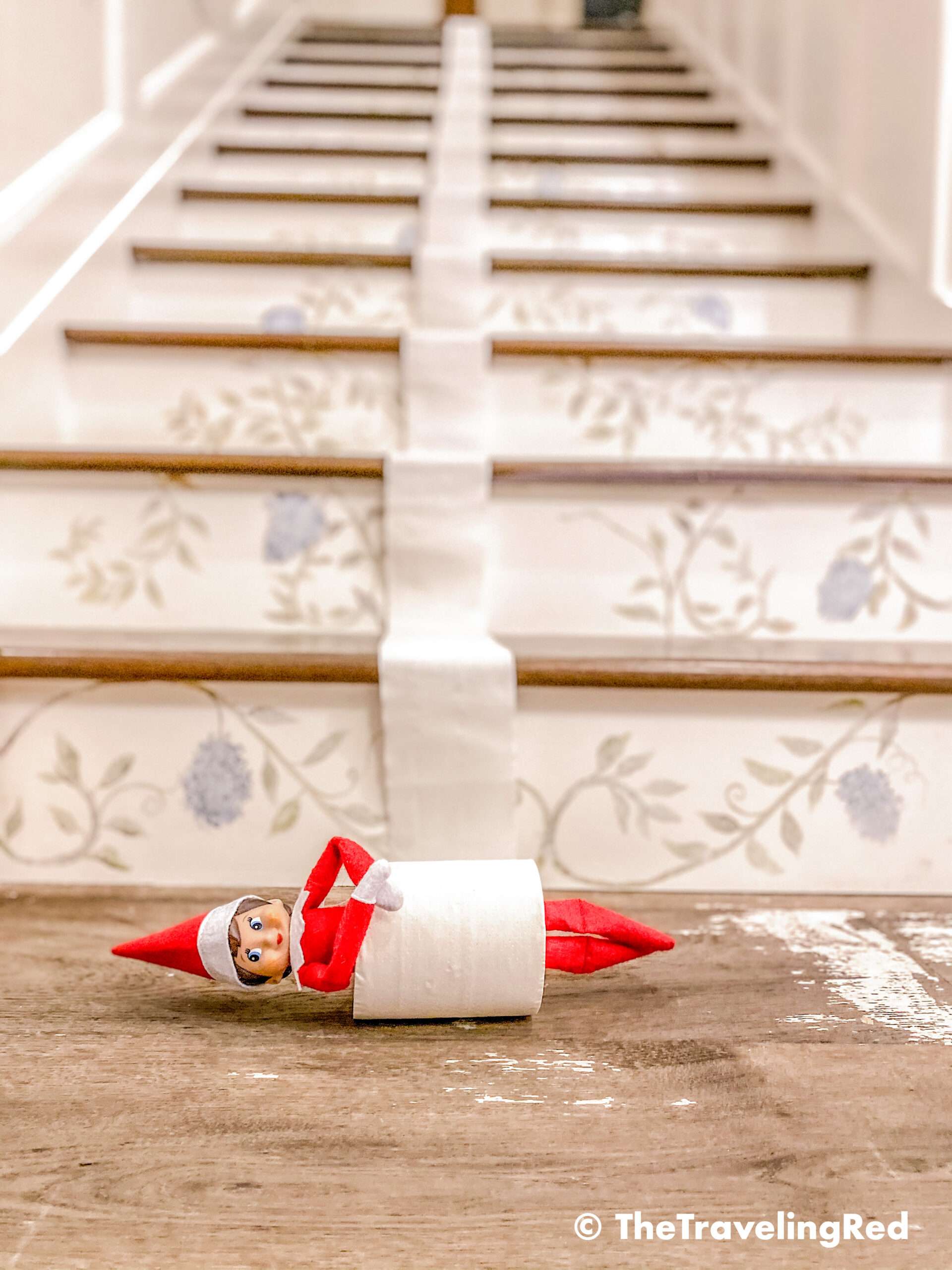 Naughty Elf on the shelf rolled down the staircase in a roll of toilet paper. Fun and easy elf on the shelf ideas for a naughty elf that are quick and easy using things you have at home.