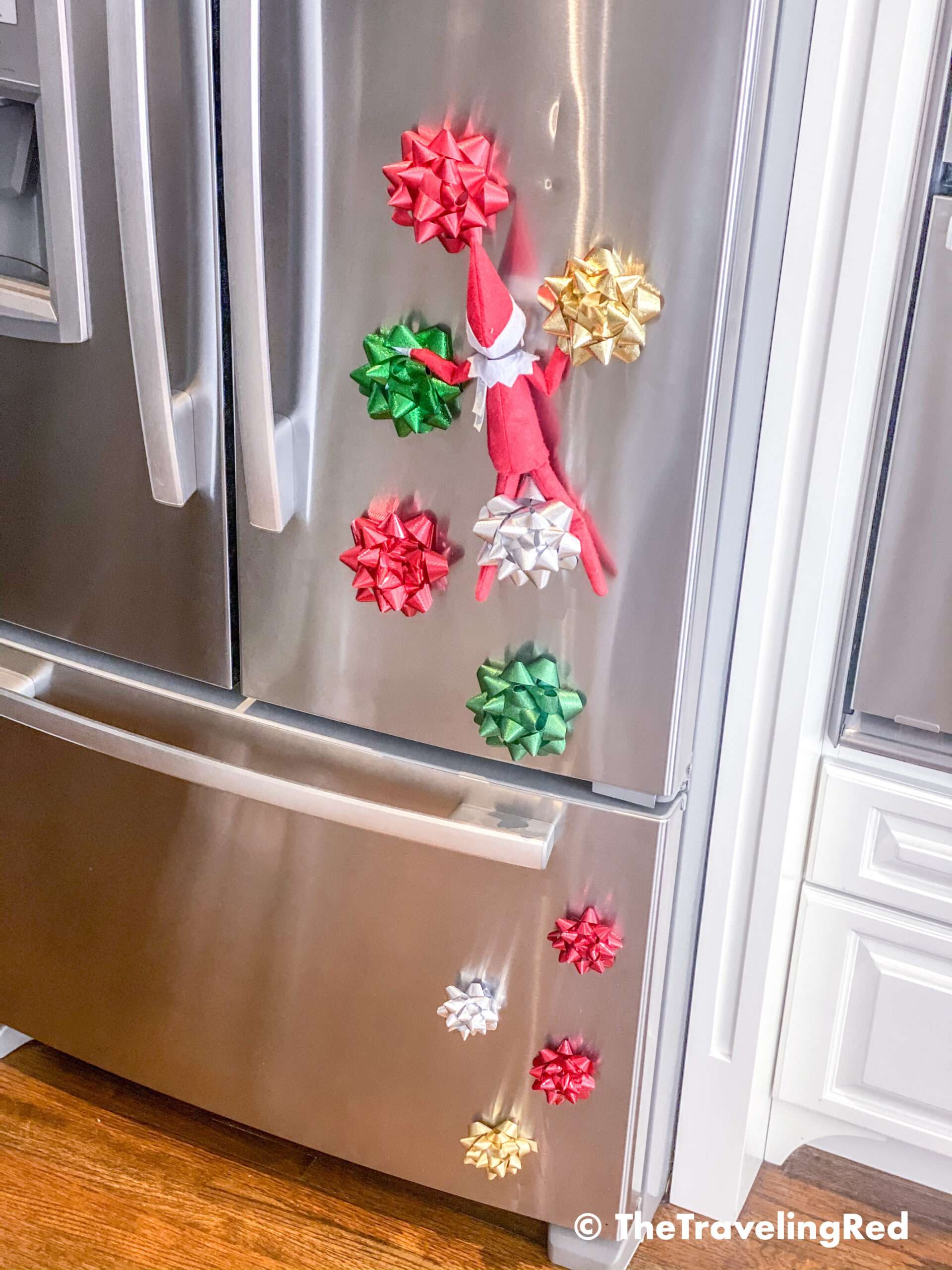 Naughty Elf on the shelf used gift bows to create a rock wall she could climb on our fridge. Fun and easy elf on the shelf ideas for a naughty elf that are quick and easy using things you have at home.
